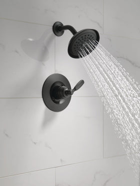 Delta Woodhurst shower handle matte black for precise water control.