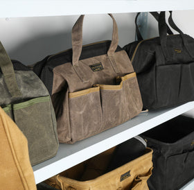 Denifiter tool bag interior reinforcement keeps large tools secure.