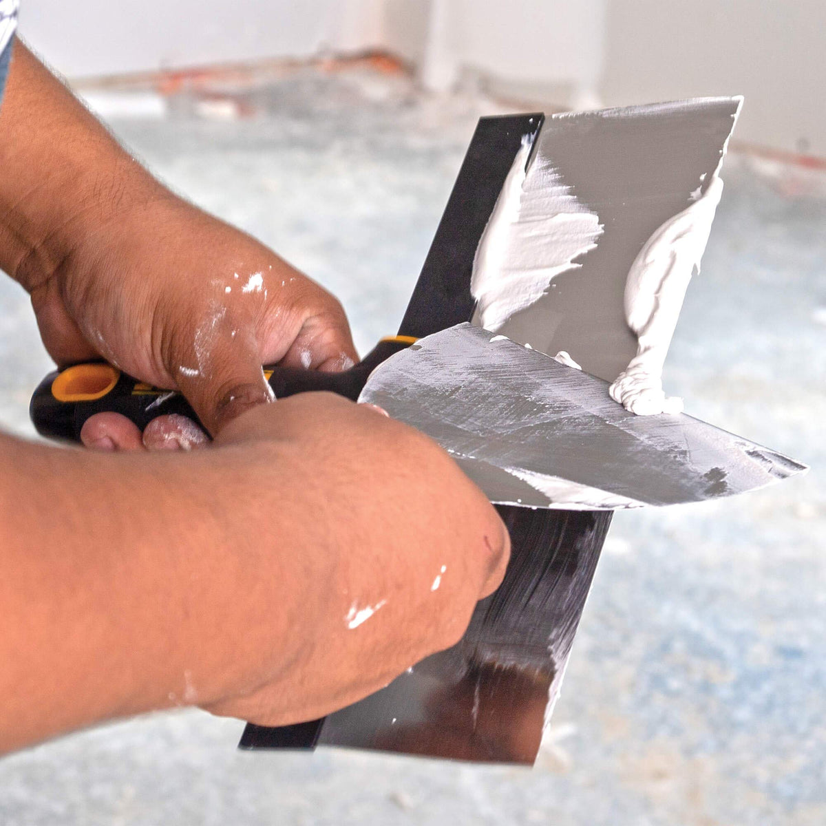 DEWALT 10-inch stainless steel taping knife with rigid backplate for better leverage.