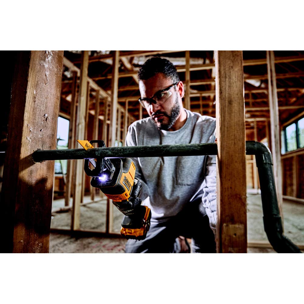 DEWALT ATOMIC 20V MAX reciprocating saw LED-light on a dark workspace