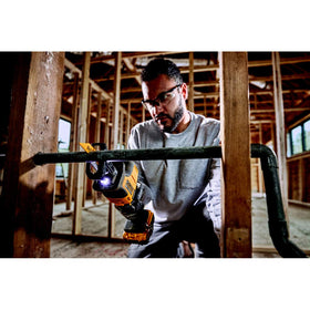 DEWALT ATOMIC 20V MAX reciprocating saw LED-light on a dark workspace