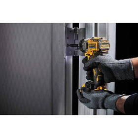DEWALT DCF601B in-hand use shows compact 4.8-inch form