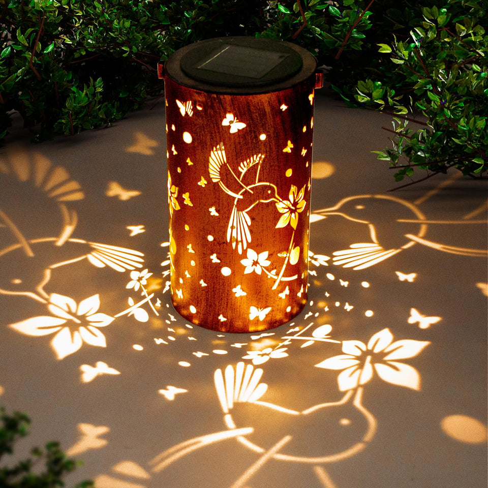 DIBIEECN solar lantern with hummingbird pattern casts warm garden light at night