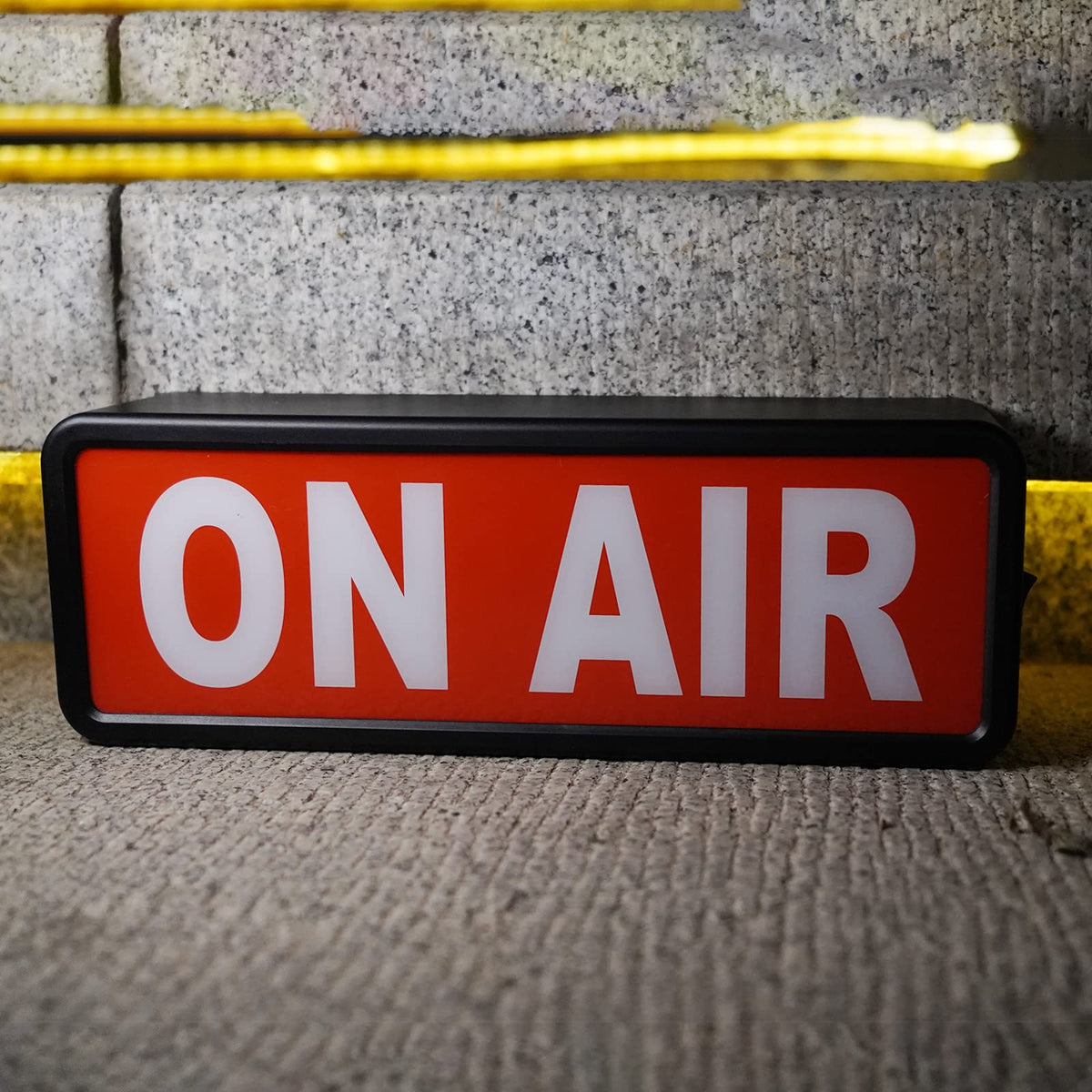 DMKYDM On Air light sign closeup showing LED glow for streams