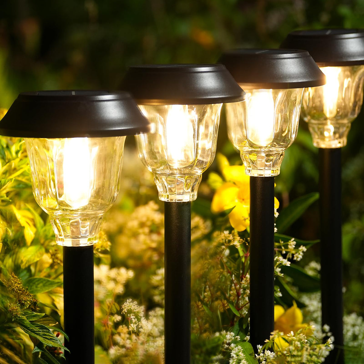 DOESLAG solar pathway light with metal frame and glass shade offers warm, inviting illumination.