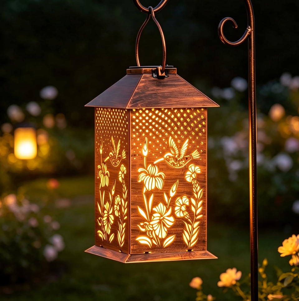 Doorkeer hummingbird solar lantern at dusk casts decorative patterns on the patio