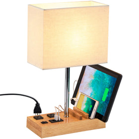 Dreamholder desk lamp with USB ports for multi-device charging at a work desk.