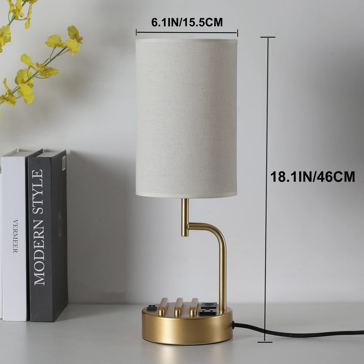 Gold-finished Dreamholder lamp on a bedside table creates warm ambient light.