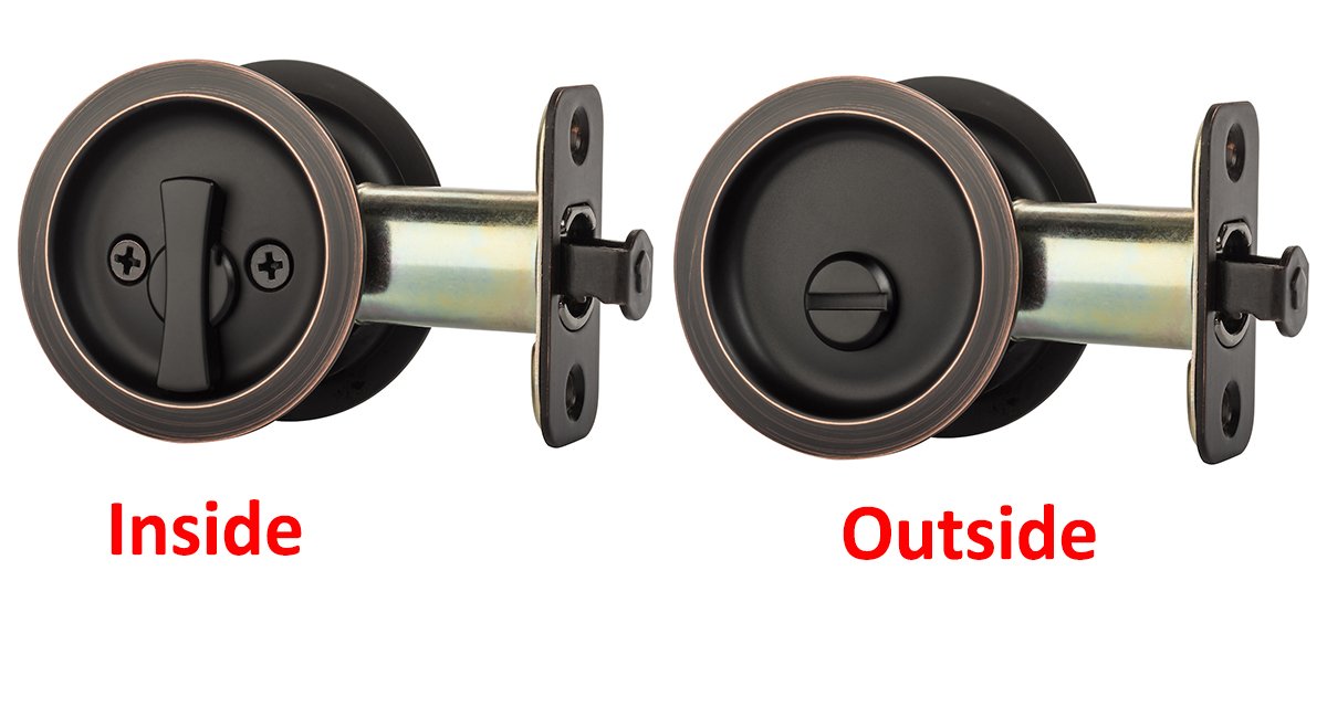 Pocket door latch installation being performed with a screwdriver