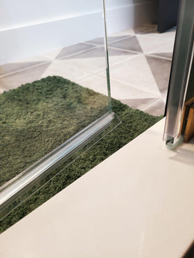 Eatelle water barrier directs moisture back into the shower area.