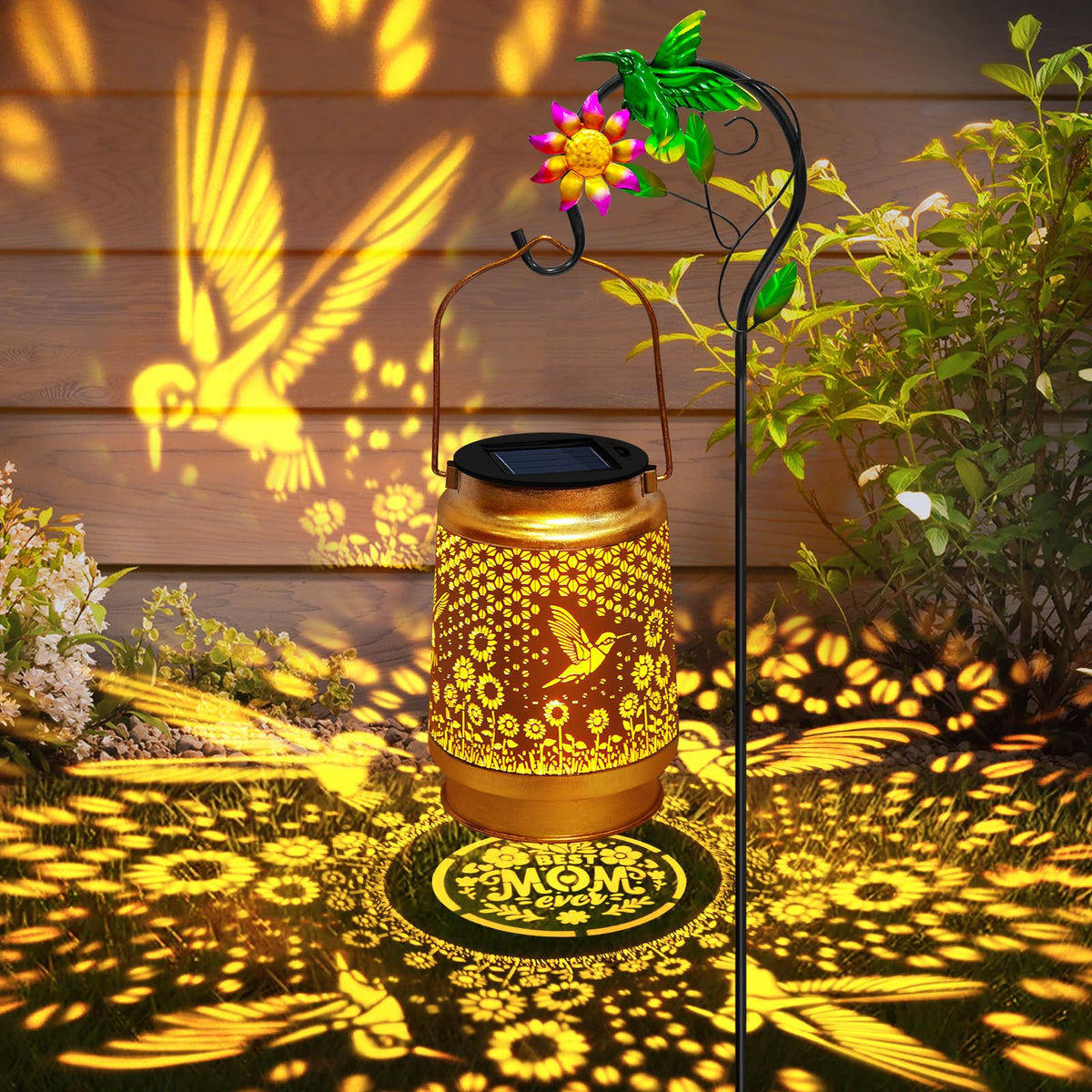 EDOF hummingbird solar lantern with shepherd hook creates warm garden lighting.