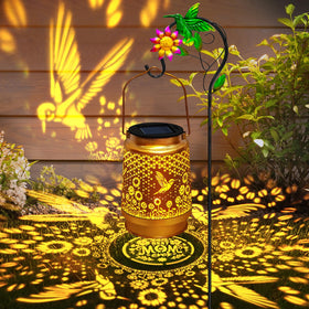 EDOF hummingbird solar lantern with shepherd hook creates warm garden lighting.