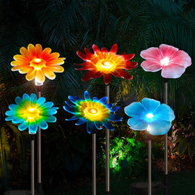 EiGreen hummingbird solar garden light adds color to outdoor spaces at dusk.