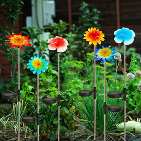 EiGreen stake light installation shows easy setup on soft ground with direct sunlight.