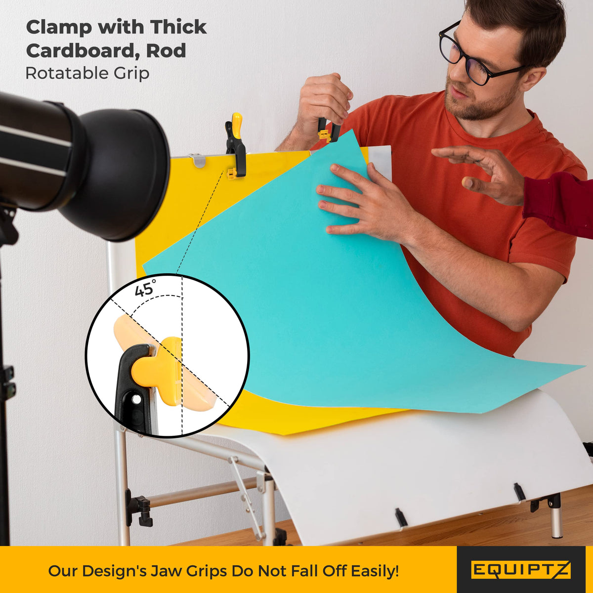 EquipTZ clamp securing a photography backdrop on a windy outdoor set