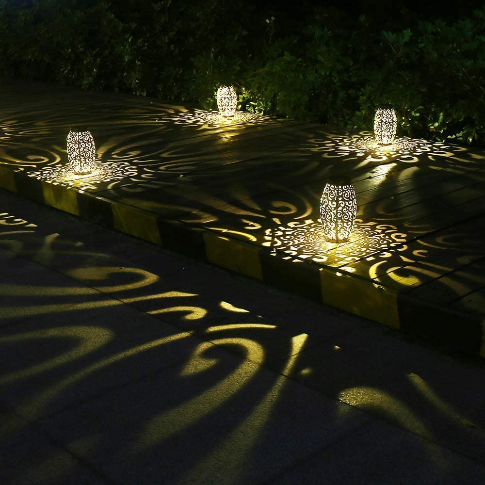 esgarden table-top solar lantern casts warm light on table