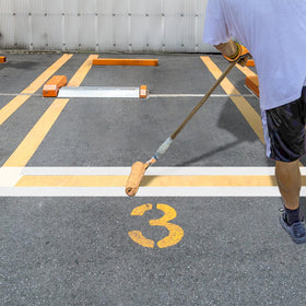 Eunika stencil on pavement for parking spaces in use