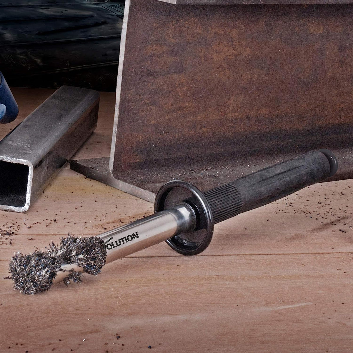 EVOLUTION Cyclone in action sweeping metal shavings from a steel bench.