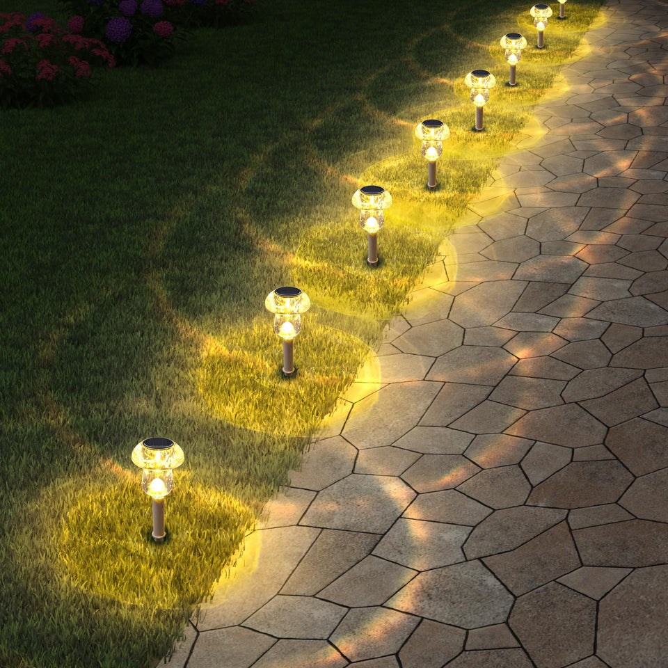 Eyrosa solar mushroom light head illuminates garden with warm white glow.