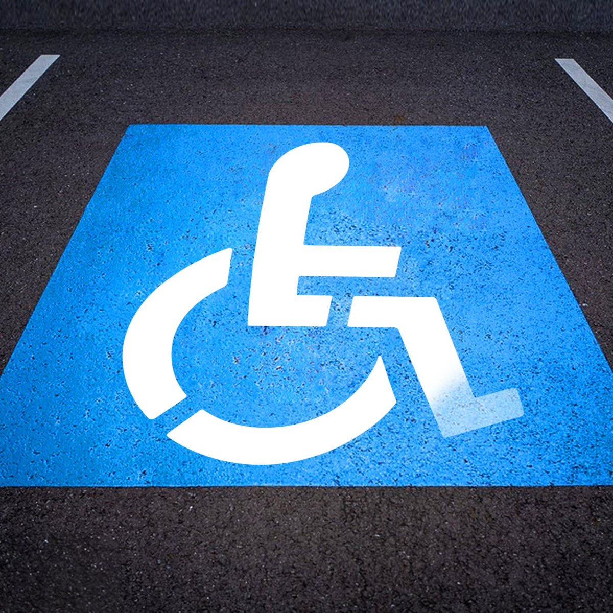 EYUNSTAR handicap parking stencil 36x36 laid on asphalt for precise, reusable markings.