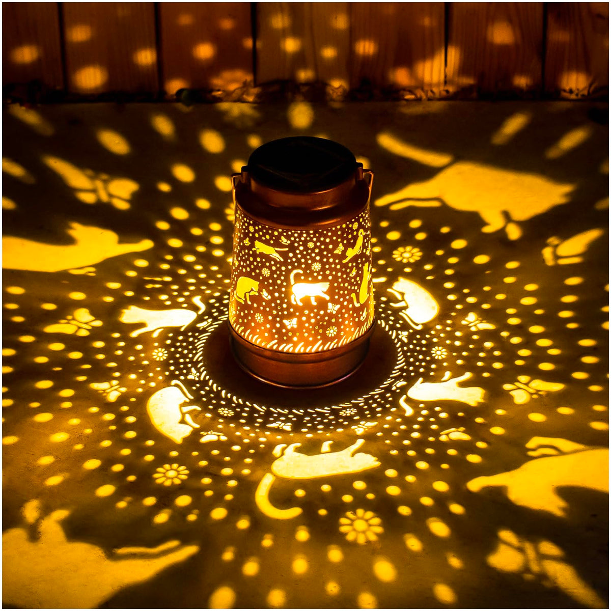 EZTZEN cat solar lantern casts decorative pattern in garden at dusk