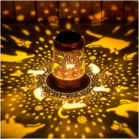 EZTZEN cat solar lantern casts decorative pattern in garden at dusk