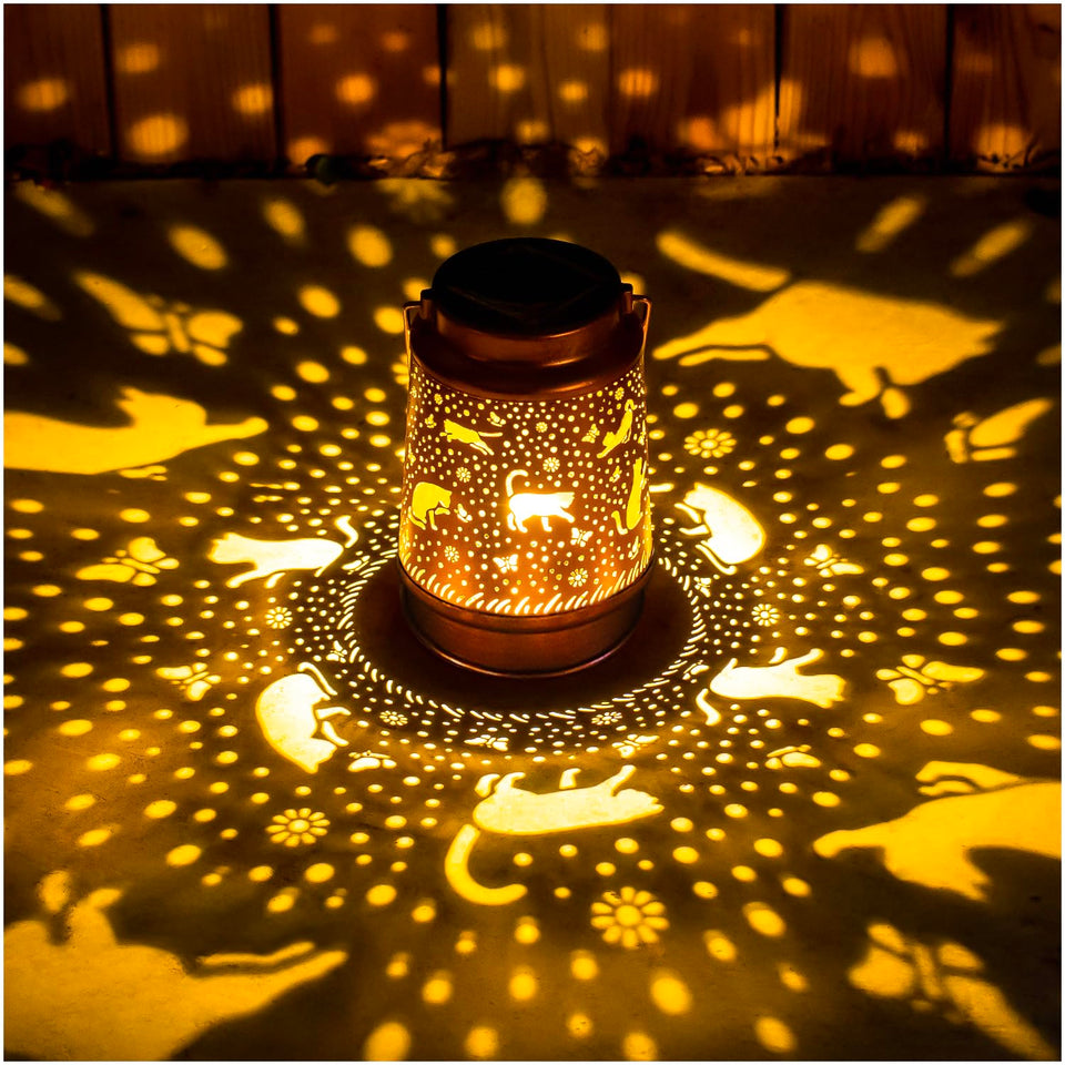 EZTZEN cat solar lantern casts decorative pattern in garden at dusk