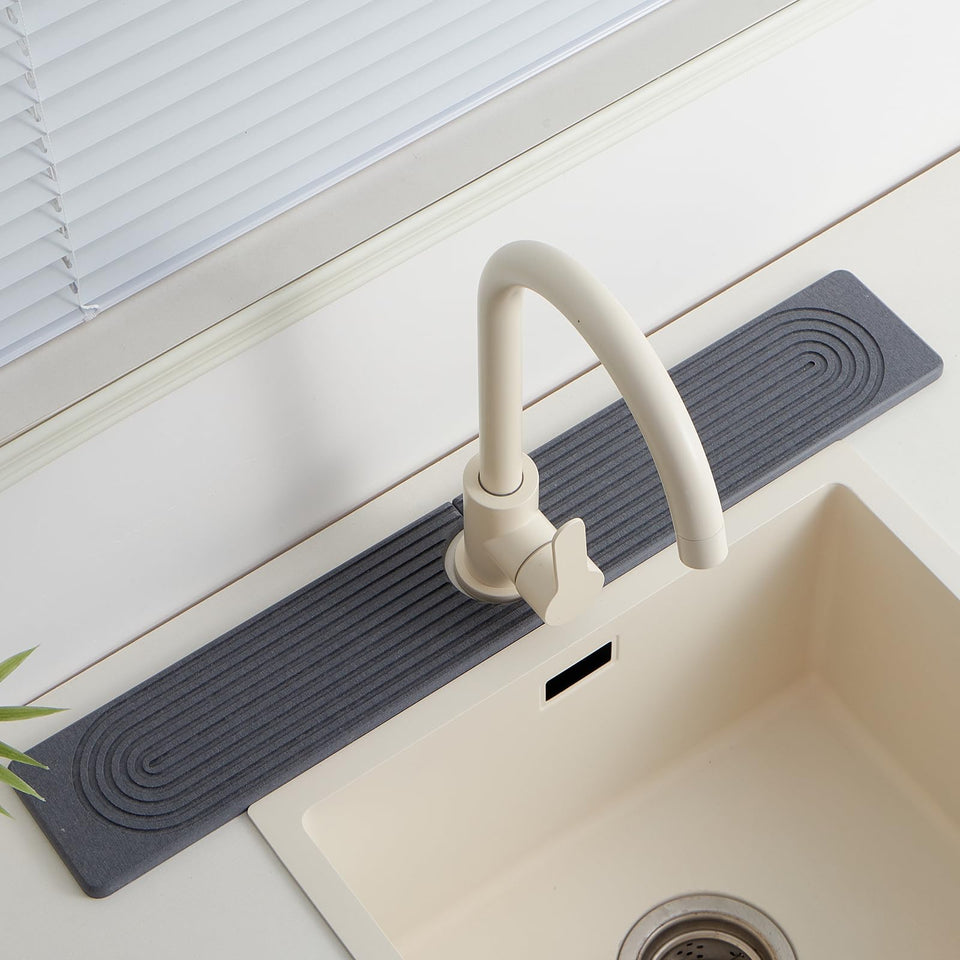 Fatilin Stone Faucet Mat on a kitchen sink, protecting the counter from splashes.