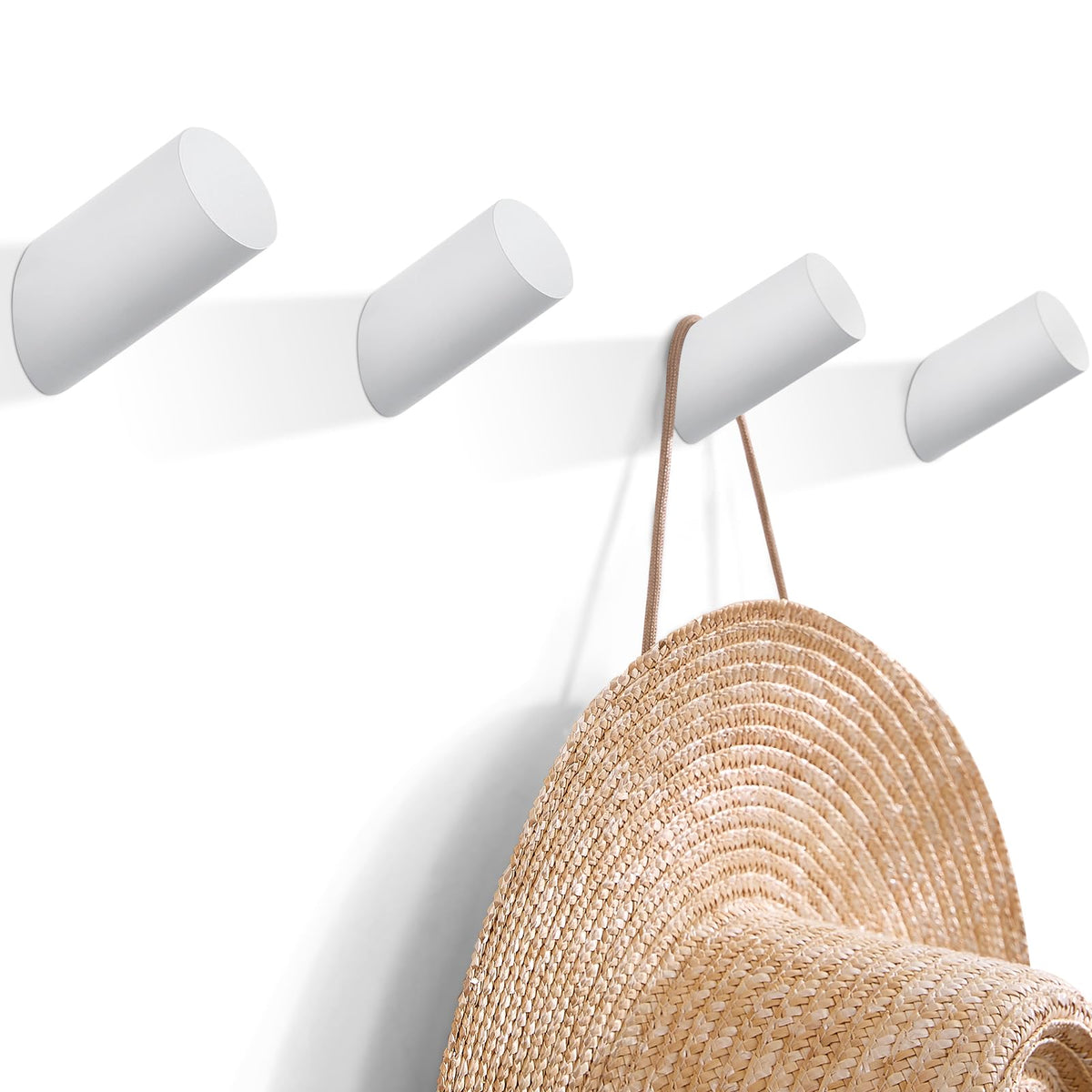 Felidio white beech entryway hook holding coats and scarves.