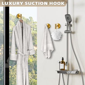 Fenas brushed gold hooks add a modern touch to bathroom decor.