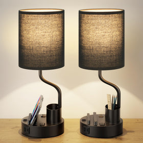 Fenmzee black bedside lamp with AC outlets for bedside device charging.