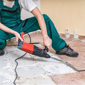 Firecore floor scraper demonstrates tile and mortar removal on concrete