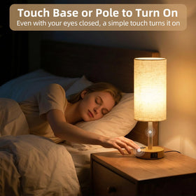 Fitfull table lamp AC outlet visible for easy bedside charging.