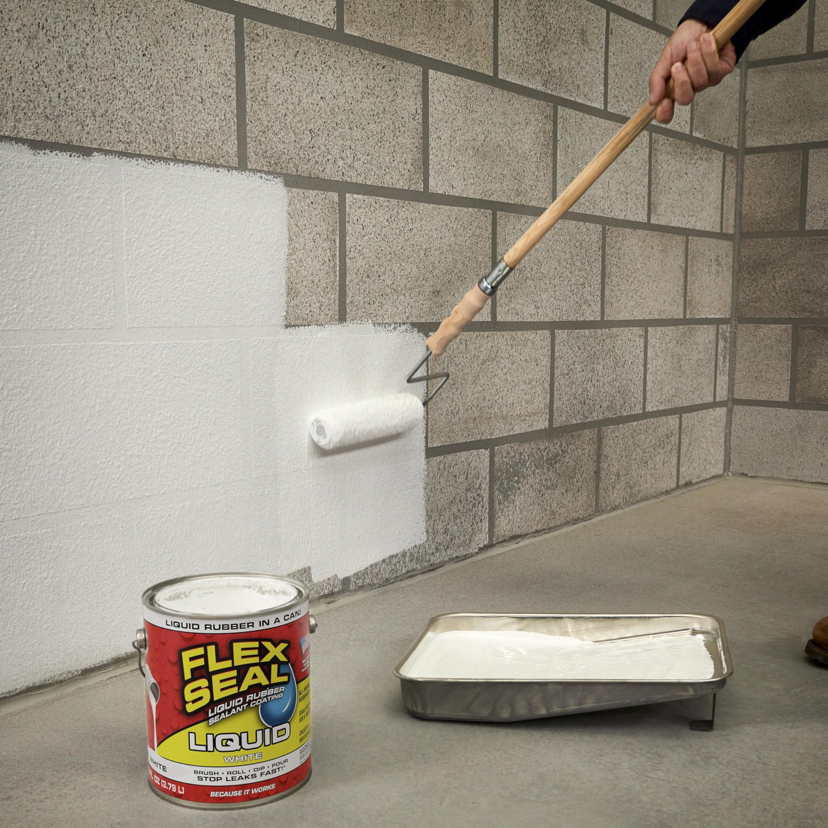 Flex Seal Liquid applied to basement wall crack for moisture protection.