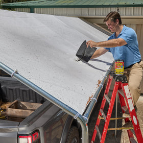 Flex Tape Original sealing an outdoor roof patch under sun exposure for UV resistance.