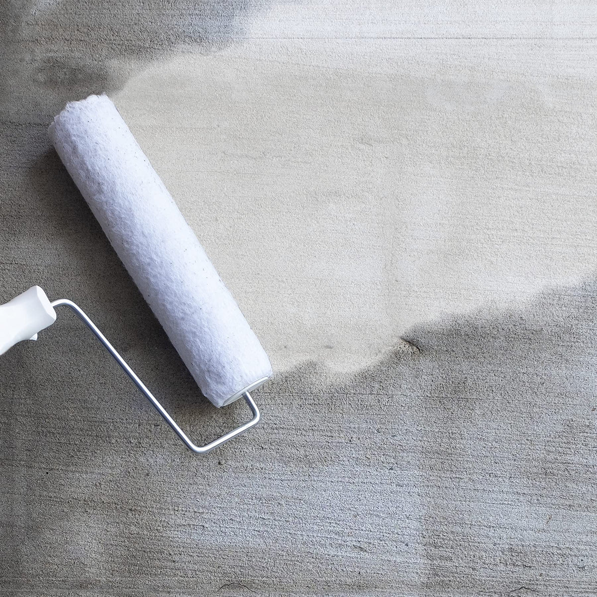 FloorPops primer applied on subfloor to ensure strong bond with peel-and-stick tiles.