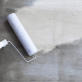 FloorPops primer applied on subfloor to ensure strong bond with peel-and-stick tiles.