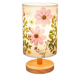 Floresita small table lamp with pressed flowers provides soft ambient light.