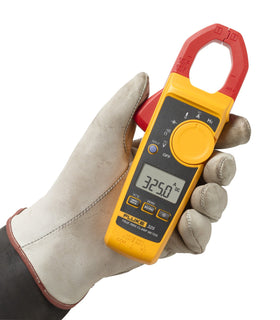 Fluke 325 clamp meter measures AC/DC voltage up to 600 V for safe panel testing.