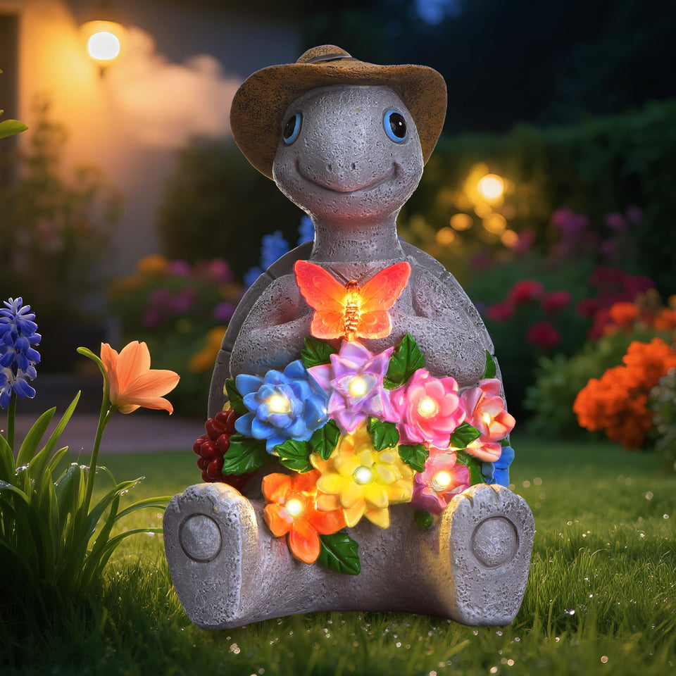 Footreal turtle statue with hat and butterfly glows softly at night for inviting outdoor spaces.