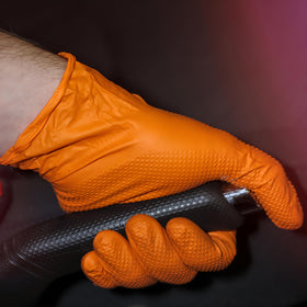 ForPro orange gloves on a workbench showing color contrast for visibility.