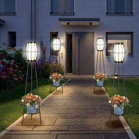 FQIIL solar tripod light lights the garden path with ambient glow.