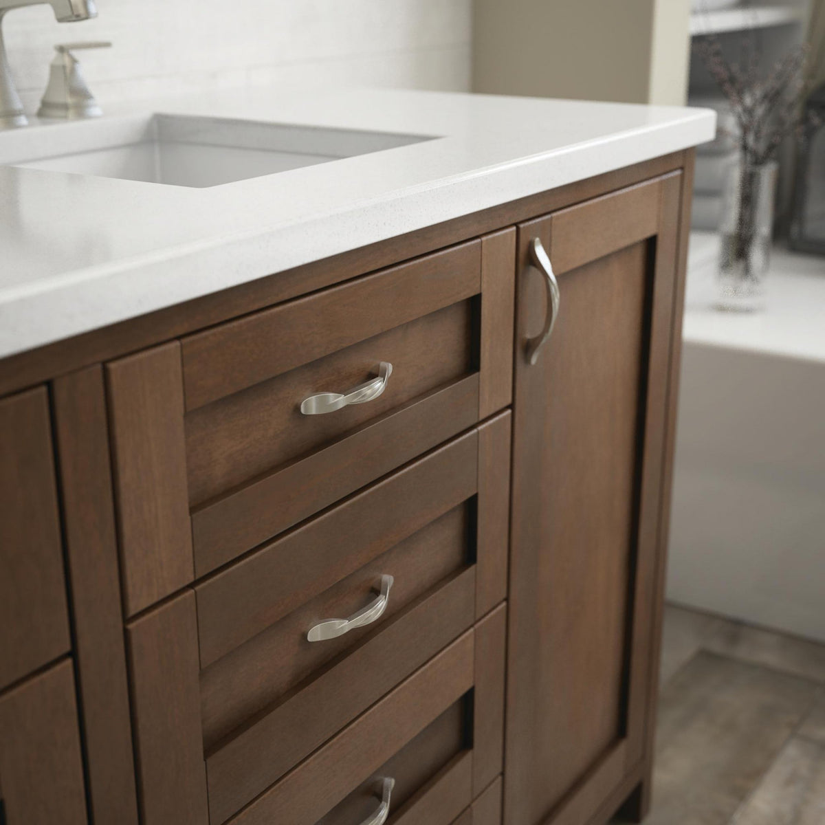 Franklin Brass satin nickel kitchen cabinet pull on door with classic style.