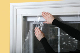 Installed Frost King kit on a framed window showing a clean edge seal
