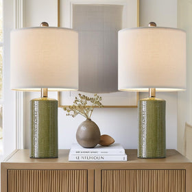 G-SAFAVA green ceramic table lamps set on a living room surface with a warm glow