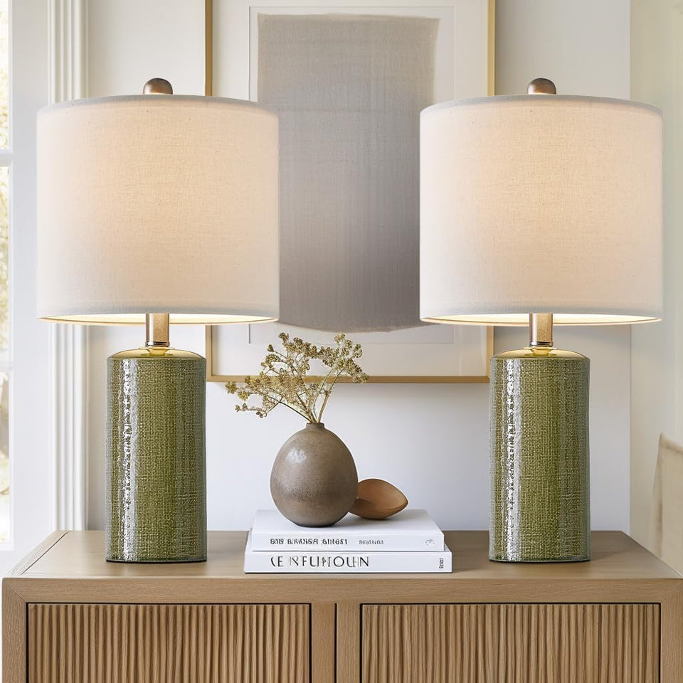 G-SAFAVA green ceramic table lamps set on a living room surface with a warm glow