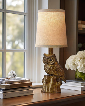 G-SAFAVA owl table lamp base detail showing stable wooden pile foundation.