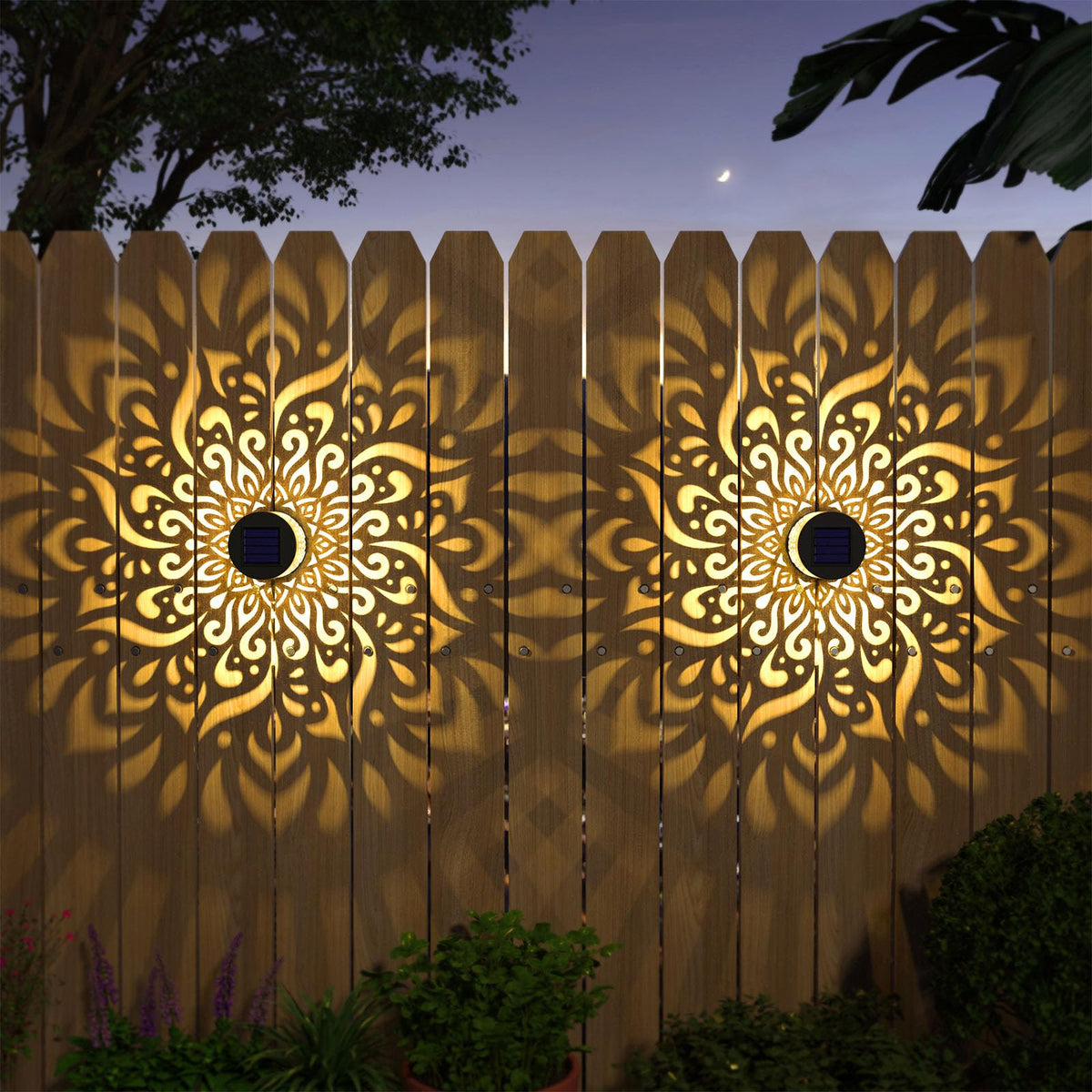 Gardencave mandala-pattern fence light projecting warm glow onto a fence