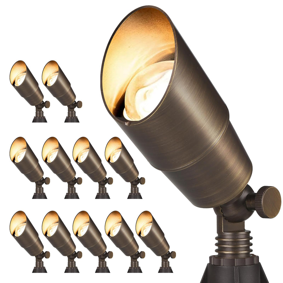 Gardencoin brass spotlight with bronze finish highlights garden paths.