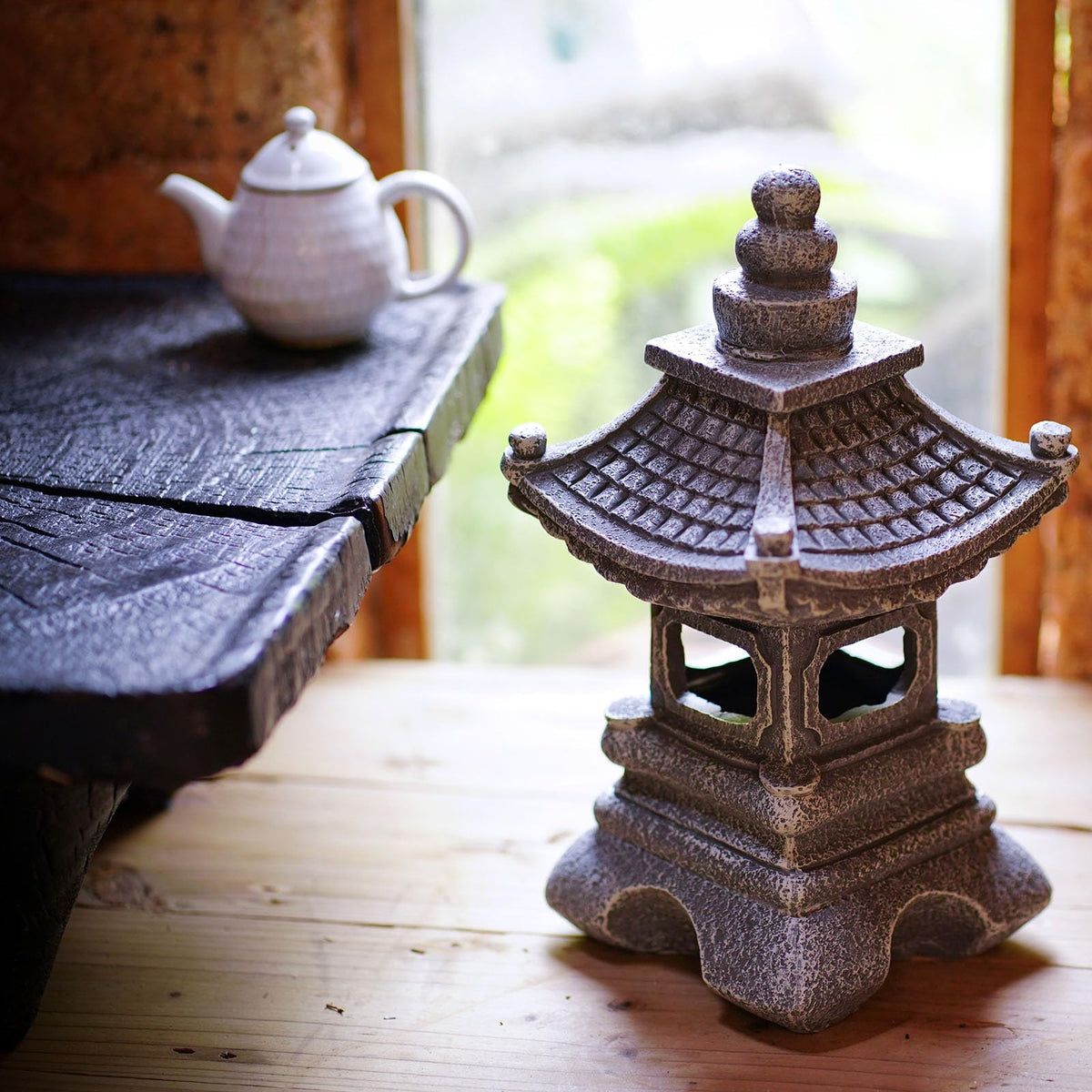 Gardenfans Solar Pagoda Lantern placed in garden bed as a subtle focal point